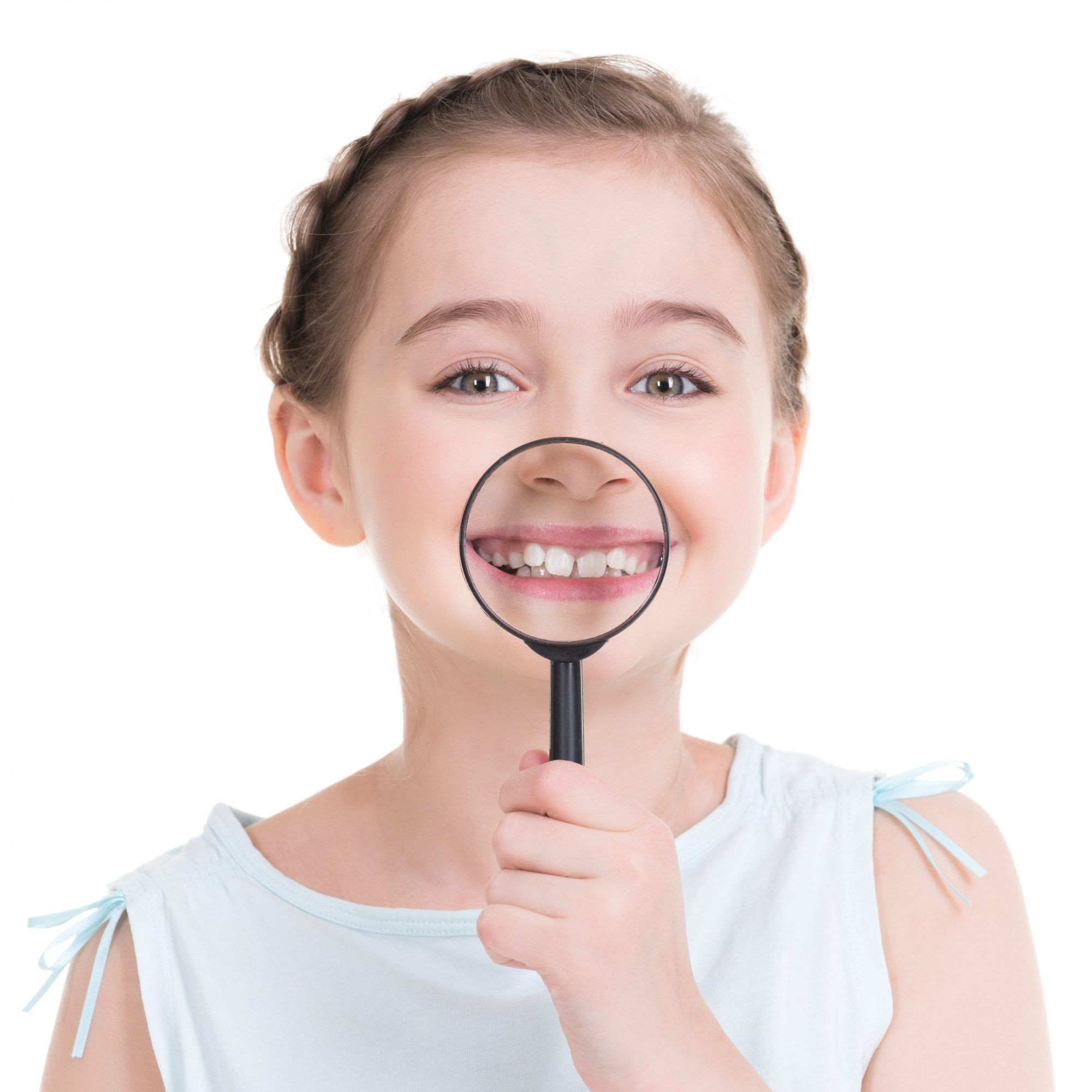 Close-up portrait of cute little girl showing teeth through a magnifying glass - isolated on white.